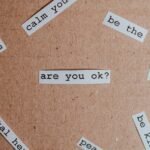 Cut-out words promoting mental health awareness on cardboard background.